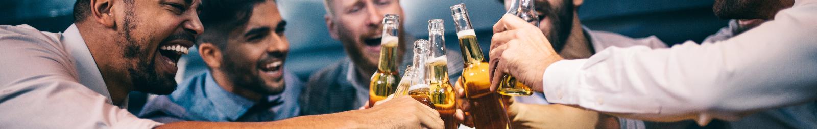 A group of men Cheers their drinks